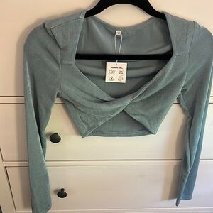 Blue Cropped Long sleeve going out top. Never worn. Size small